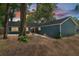 Exterior front view of home featuring mature trees and a long driveway at 1841 Ne 38Th St, Ocala, FL 34479