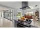 View of the kitchen with granite countertops, stainless steel range hood and access to the backyard at 1841 Ne 38Th St, Ocala, FL 34479