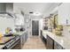 Modern kitchen features granite countertops, farmhouse sink, and stainless steel appliances at 1841 Ne 38Th St, Ocala, FL 34479