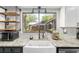Bright kitchen sink with granite countertops, stainless steel appliances, and a view of the backyard at 1841 Ne 38Th St, Ocala, FL 34479