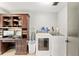 Functional laundry room featuring modern washer and dryer, storage cabinet, and desk space at 1841 Ne 38Th St, Ocala, FL 34479
