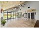 Spacious living room features high ceilings, wood floors, and a wall of windows, offering natural light at 1841 Ne 38Th St, Ocala, FL 34479
