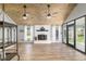 Bright living room with wood-look floors, beamed wood ceiling, fireplace, large windows, and backyard views at 1841 Ne 38Th St, Ocala, FL 34479