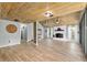 Bright living room with wood-look floors, beamed wood ceiling, fireplace, and large windows at 1841 Ne 38Th St, Ocala, FL 34479