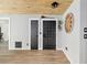 Open floor plan with wood-look floors and beamed wood ceiling at 1841 Ne 38Th St, Ocala, FL 34479