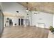 Open-concept living room with high ceilings, wood floors, and neutral paint, perfect for modern living at 1841 Ne 38Th St, Ocala, FL 34479