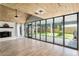 Sunlit living room features wood ceiling, fireplace, large windows, and easy access to outdoor patio at 1841 Ne 38Th St, Ocala, FL 34479