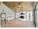 Inviting living room with fireplace, wood ceilings, and large windows offering views of the backyard at 1841 Ne 38Th St, Ocala, FL 34479