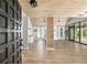 Spacious living room boasts an open floor plan, wood-look floors, beamed wood ceiling and natural light from large windows at 1841 Ne 38Th St, Ocala, FL 34479