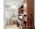 View of the office space featuring built-in wooden shelves and desk area with a window and light-colored walls at 1841 Ne 38Th St, Ocala, FL 34479