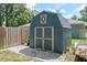 Backyard shed featuring double doors and decorative trim at 1841 Ne 38Th St, Ocala, FL 34479
