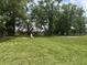 Spacious backyard with lush green grass and ample space for outdoor activities and landscaping at 185 Malauka Loop, Ocklawaha, FL 32179