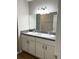 Bathroom featuring a double sink vanity with modern fixtures and a large mirror at 185 Malauka Loop, Ocklawaha, FL 32179