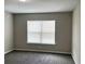 Clean, empty bedroom with neutral walls, carpeted flooring and a window at 185 Malauka Loop, Ocklawaha, FL 32179