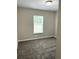 Bedroom with neutral walls, carpet flooring, and a window that provides ample natural light at 185 Malauka Loop, Ocklawaha, FL 32179