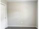 Bedroom with neutral walls, white trim, carpet flooring, and a white door at 185 Malauka Loop, Ocklawaha, FL 32179