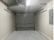 Clean, well-lit garage with modern door, ready for vehicles and storage, enhancing your home's functionality at 185 Malauka Loop, Ocklawaha, FL 32179