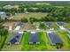 Aerial shot showcases a neighborhood with well-kept lawns, modern homes, and lush green spaces at 19424 Sw 77Th Loop, Dunnellon, FL 34432