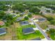 An aerial view showcasing a residential neighborhood with well-maintained lawns, pools, and varied home styles at 19424 Sw 77Th Loop, Dunnellon, FL 34432