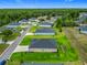 Scenic aerial view of a home in a neighborhood, highlighting the manicured lawns and community layout at 19424 Sw 77Th Loop, Dunnellon, FL 34432