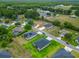 An aerial view showcasing a residential neighborhood with well-maintained lawns, pools, and varied home styles at 19424 Sw 77Th Loop, Dunnellon, FL 34432