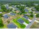 An aerial view showcasing a residential neighborhood with well-maintained lawns and varied home styles at 19424 Sw 77Th Loop, Dunnellon, FL 34432