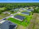 Drone shot showcasing a beautiful neighborhood with green lawns and well-maintained homes surrounded by trees at 19424 Sw 77Th Loop, Dunnellon, FL 34432
