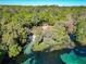 Panoramic aerial view of the swimming spot, surrounded by rich greenery and with inviting clear blue water at 19424 Sw 77Th Loop, Dunnellon, FL 34432