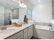 Bathroom showcasing double sinks, and a glass shower providing a spa-like experience at 19424 Sw 77Th Loop, Dunnellon, FL 34432