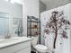 Clean and modern bathroom with beautiful decorative tree shower curtain at 19424 Sw 77Th Loop, Dunnellon, FL 34432