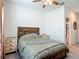 Cozy bedroom with wooden bed frame and lots of light from ceiling fan at 19424 Sw 77Th Loop, Dunnellon, FL 34432