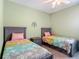 Charming bedroom with two twin beds, a ceiling fan and carpet flooring at 19424 Sw 77Th Loop, Dunnellon, FL 34432
