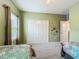 Bedroom with green walls, closet and two beds with unique bedding at 19424 Sw 77Th Loop, Dunnellon, FL 34432