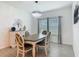 Chic dining room showcasing a modern chandelier, elegant furnishings, and neutral decor at 19424 Sw 77Th Loop, Dunnellon, FL 34432