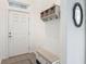 Bright entryway with storage bench, coat rack, and decorative mirror for added convenience at 19424 Sw 77Th Loop, Dunnellon, FL 34432