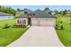 Charming single-story home with a well-manicured lawn, red shutters, and a two-car garage at 19424 Sw 77Th Loop, Dunnellon, FL 34432