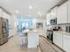 Spacious kitchen with an island, stainless steel appliances, and white cabinets offers lots of storage at 19424 Sw 77Th Loop, Dunnellon, FL 34432