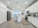 Wide angle of a modern kitchen featuring all-white cabinets, stainless appliances and central island at 19424 Sw 77Th Loop, Dunnellon, FL 34432