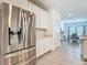 Modern kitchen includes stainless steel refrigerator, white cabinets, and a view into the dining area at 19424 Sw 77Th Loop, Dunnellon, FL 34432