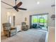 Cozy living room with carpet, ceiling fan, and sliding doors to the outside at 19424 Sw 77Th Loop, Dunnellon, FL 34432