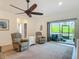 Comfortable living room featuring plush seating, sliding glass doors, and a ceiling fan at 19424 Sw 77Th Loop, Dunnellon, FL 34432