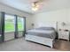 Bedroom with a ceiling fan, windows, and neutral decor create a peaceful retreat at 19424 Sw 77Th Loop, Dunnellon, FL 34432