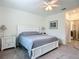 Inviting main bedroom with a ceiling fan and ensuite bathroom at 19424 Sw 77Th Loop, Dunnellon, FL 34432