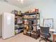 Well-organized pantry with shelving and a desk, complemented by a fridge at 19424 Sw 77Th Loop, Dunnellon, FL 34432