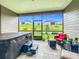 Screened-in patio with a hot tub and outdoor seating, perfect for relaxation and enjoying the backyard view at 19424 Sw 77Th Loop, Dunnellon, FL 34432