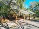 Covered picnic shelter with seating and grilling area in a natural, wooded setting at 19424 Sw 77Th Loop, Dunnellon, FL 34432