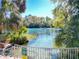 View of the clear spring-fed water with lush vegetation and signs indicating wildlife at 19424 Sw 77Th Loop, Dunnellon, FL 34432