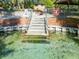 A staircase descends into a clear, inviting swimming pool, surrounded by a brick barrier at 19424 Sw 77Th Loop, Dunnellon, FL 34432