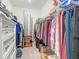 Organized walk-in closet with shelving and hanging rods, maximizing storage space at 19424 Sw 77Th Loop, Dunnellon, FL 34432