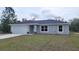 Single-story home featuring a two-car garage, stone accents, and a well-maintained lawn at 20154 Sw Rainbow Lakes Blvd, Dunnellon, FL 34431